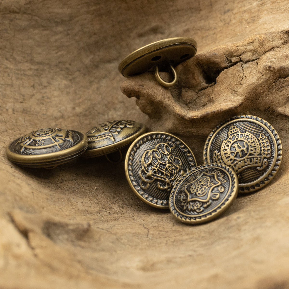 Antique bronze brass buttons with round crest emblems, mixed front views