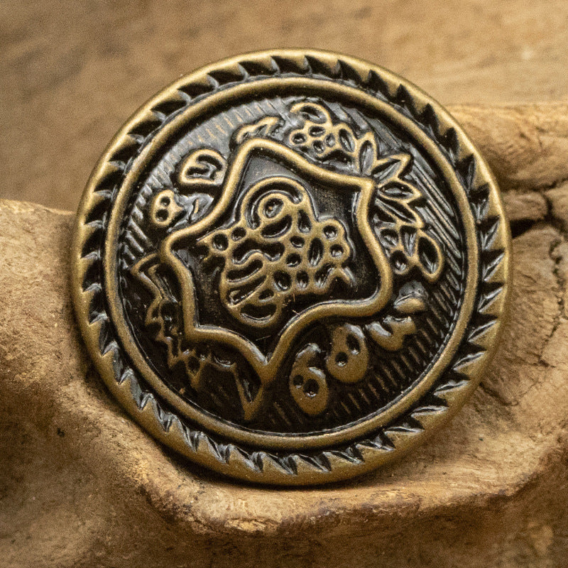 Round antique bronze brass button with animal crest emblem and spiked border