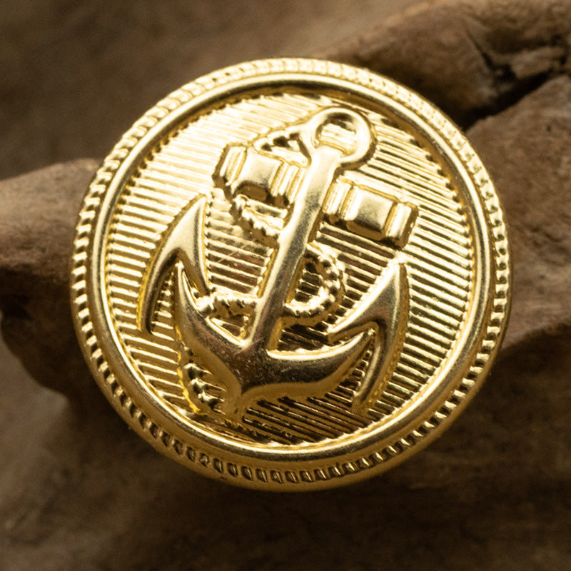 Gold anchor emblem metal button, round front with ridged border and anchor design
