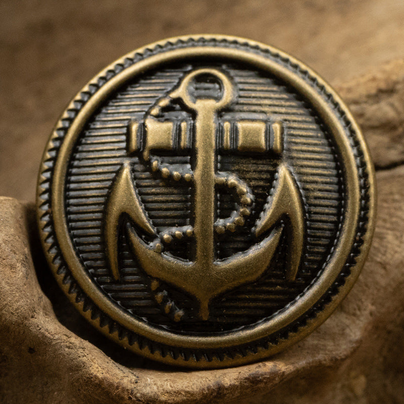 Bronze anchor emblem metal button, round front with ridged border and anchor design