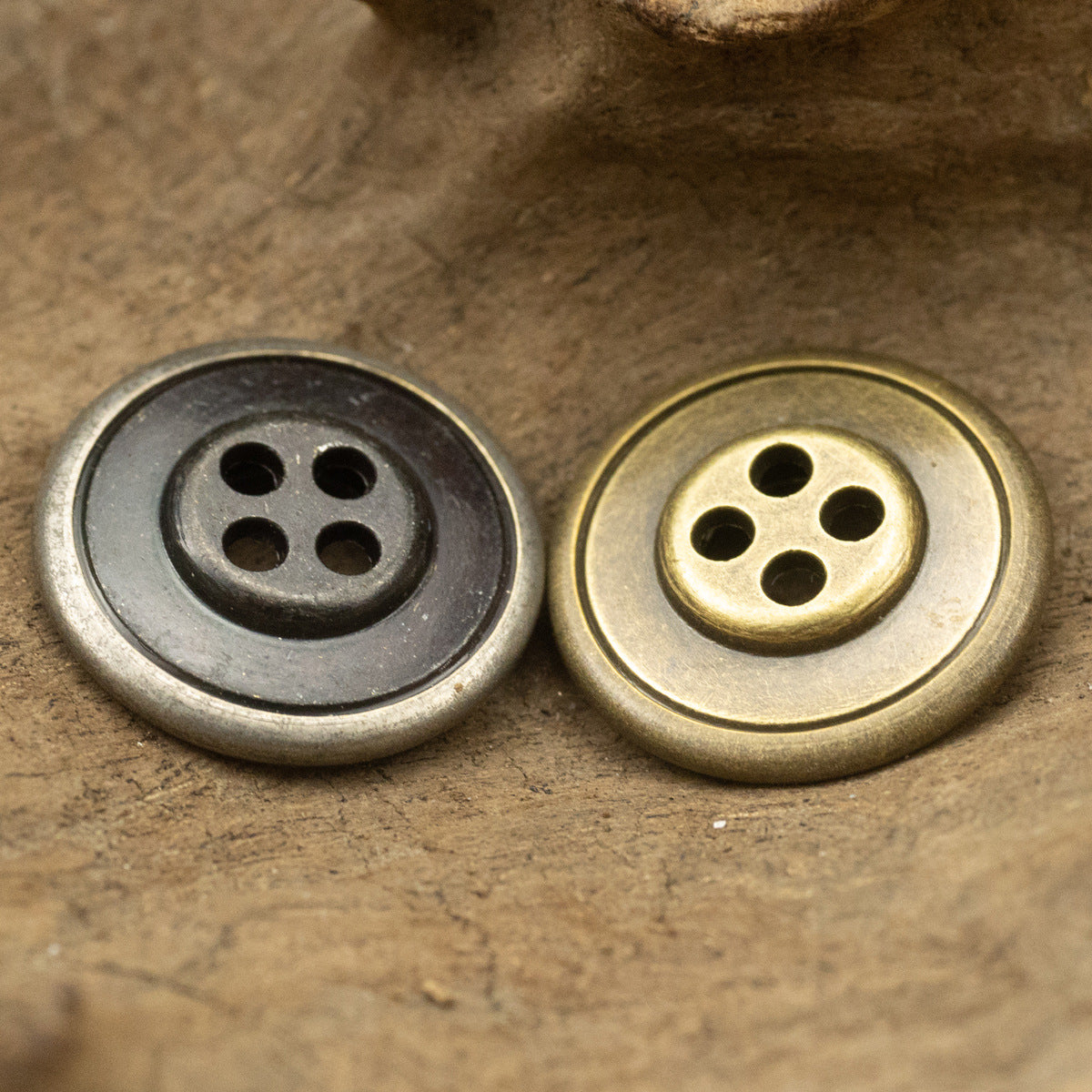Round metal buttons with 4 holes and laurel element pattern, black nickel