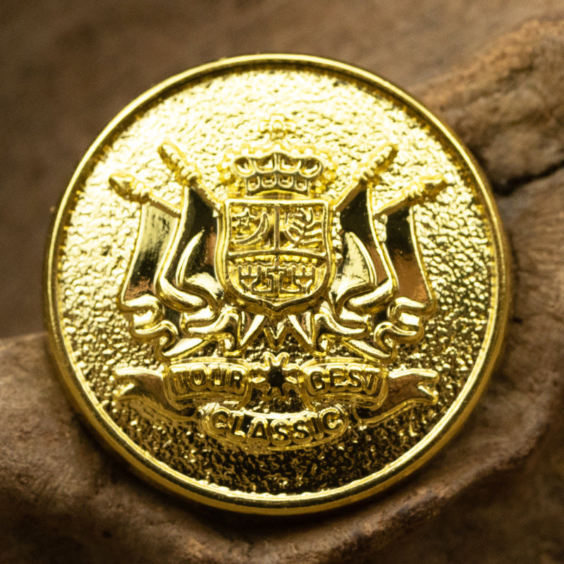 Golden lion shield metal button with crown emblem, round front, close-up