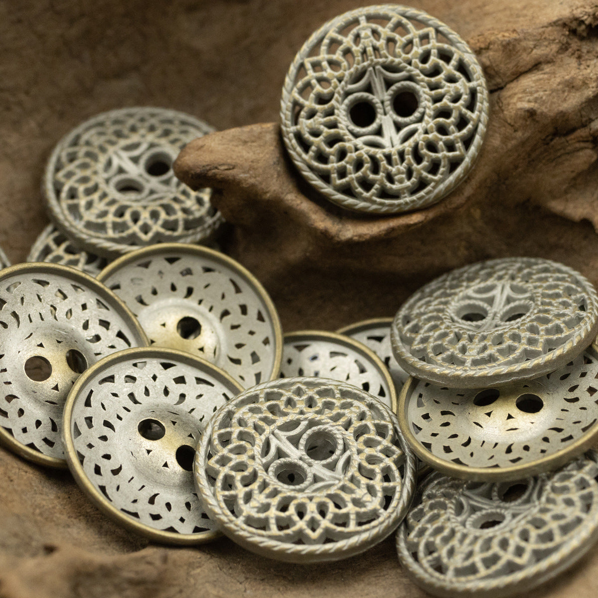 Six-pack bronze decorative buttons with intricate cutout lace pattern and two-hole face