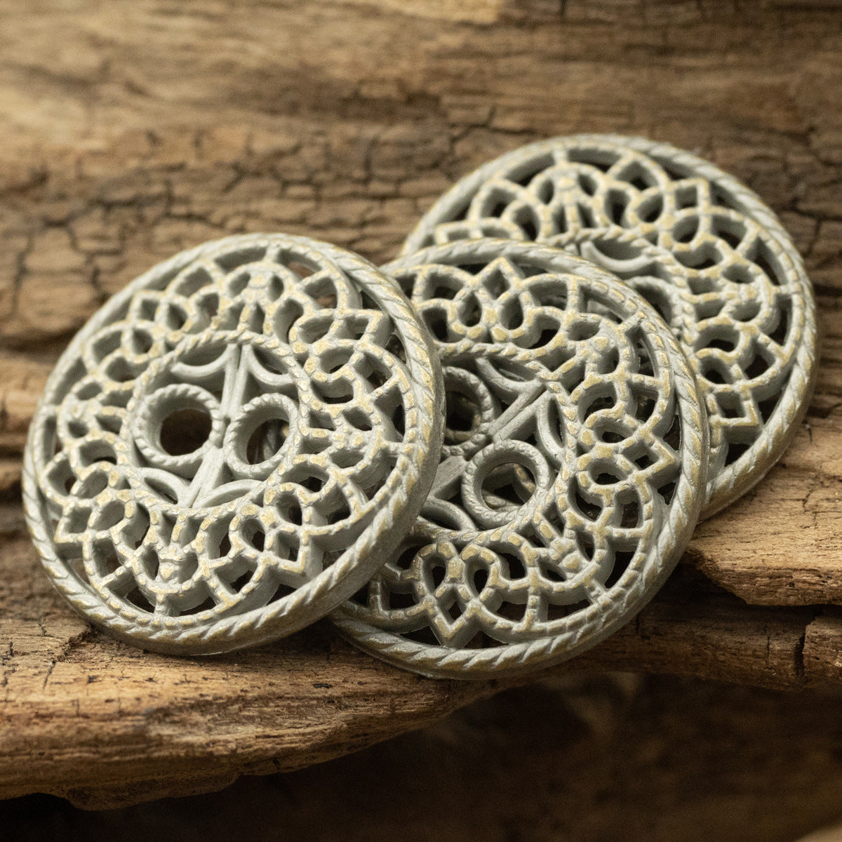 Set of round bronze decorative buttons with hollow antique filigree and two-hole centers