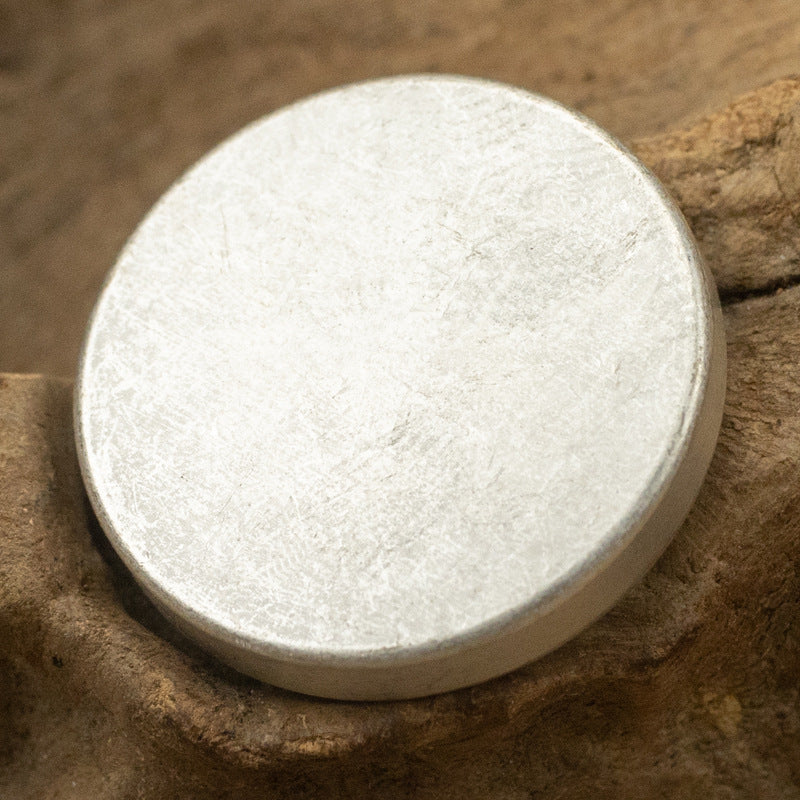 Round flat metal button with shank, textured silver-white