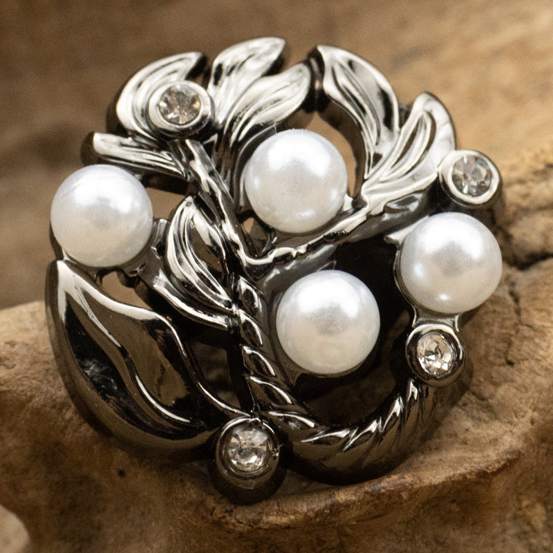 Black leaf metal button with white pearl centers and diamond-inlaid accents
