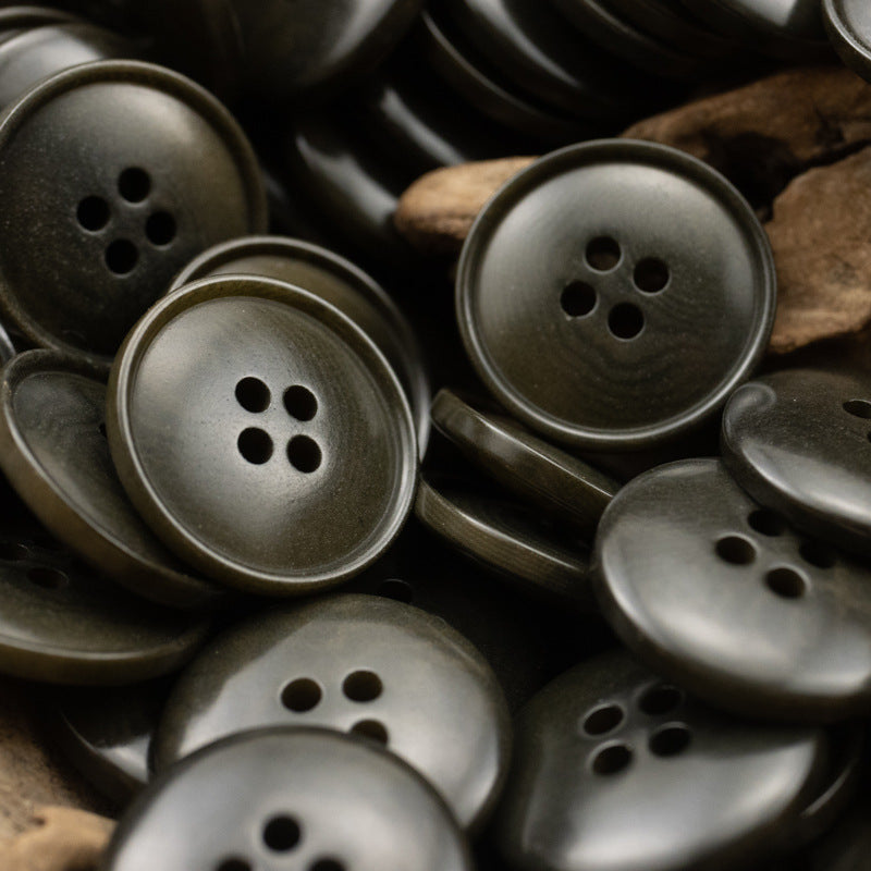 Assorted round 4-hole vintage buttons in dark gray-green with metallic sheen