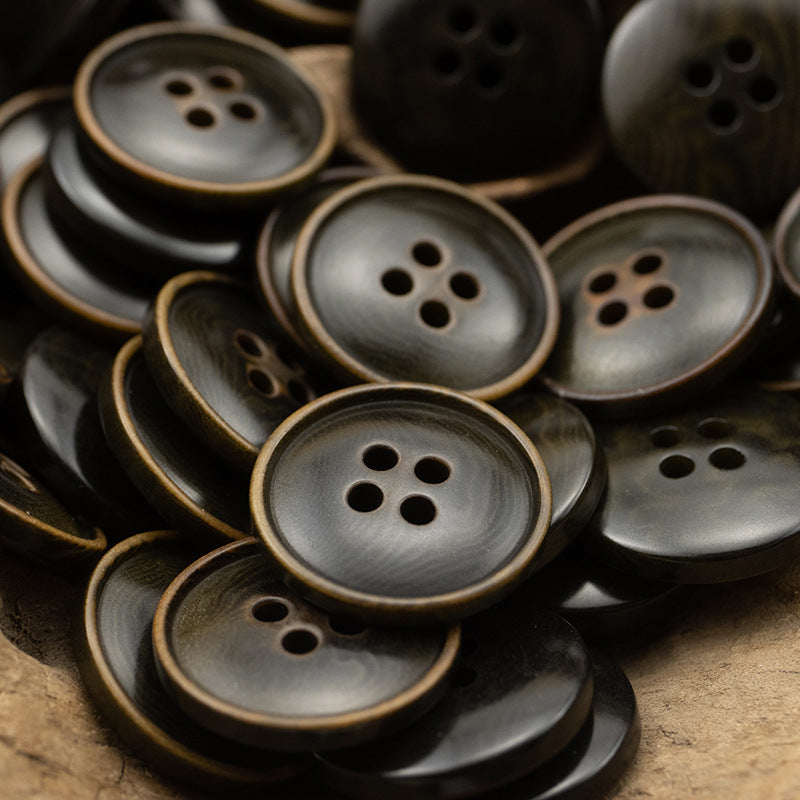 Multiple round 4-hole vintage buttons in dark gray with light rim edges