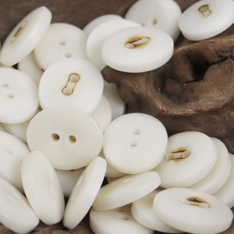White oval corozo buttons with two holes, charred finish, 10pcs
