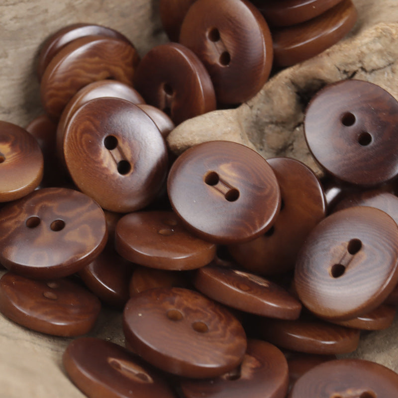 Wine-brown oval corozo buttons with two holes, charred finish, 10pcs