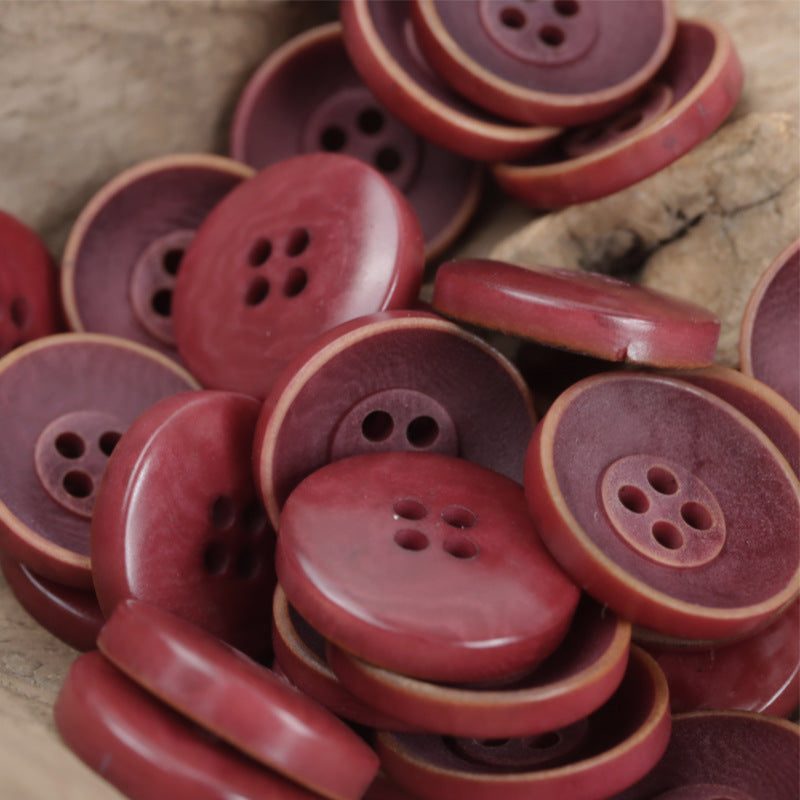 Bowl-shaped buttons in magenta and burgundy, round face with multi-hole pattern
