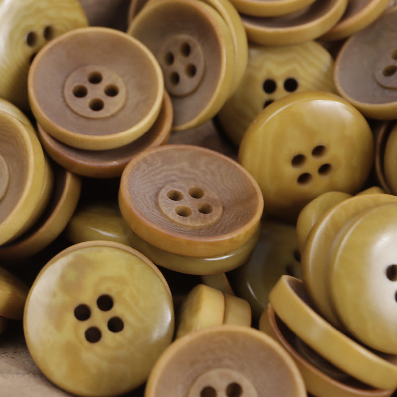 Bowl-shaped buttons in ginger yellow tones, round face with 4-hole design