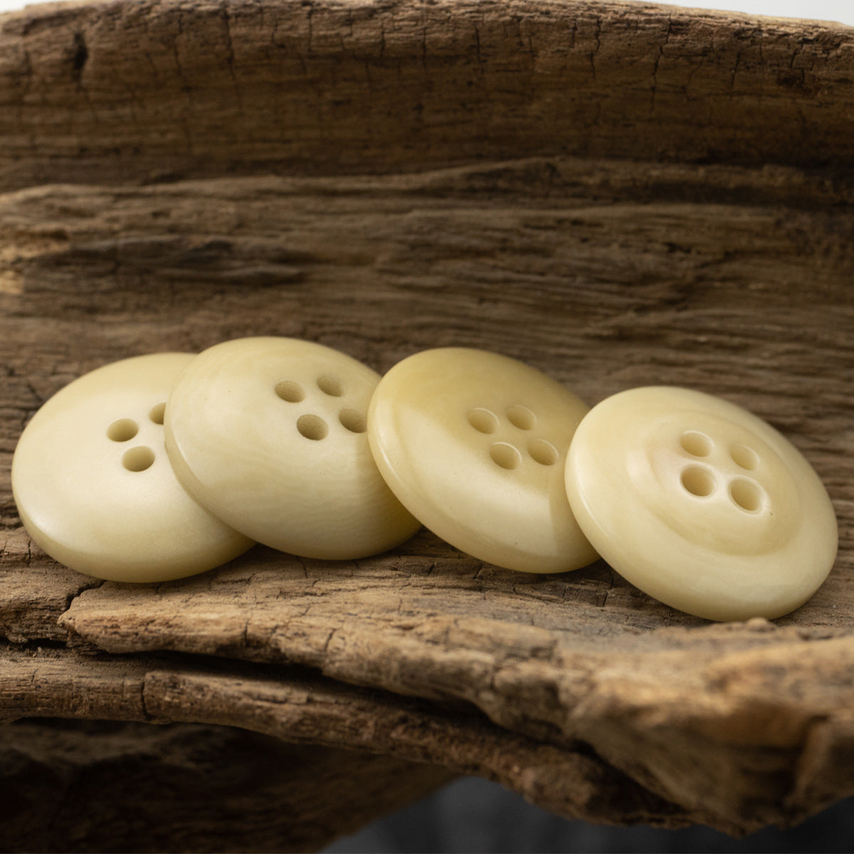 Light yellow 4-hole fruit buttons set, visible front and back faces
