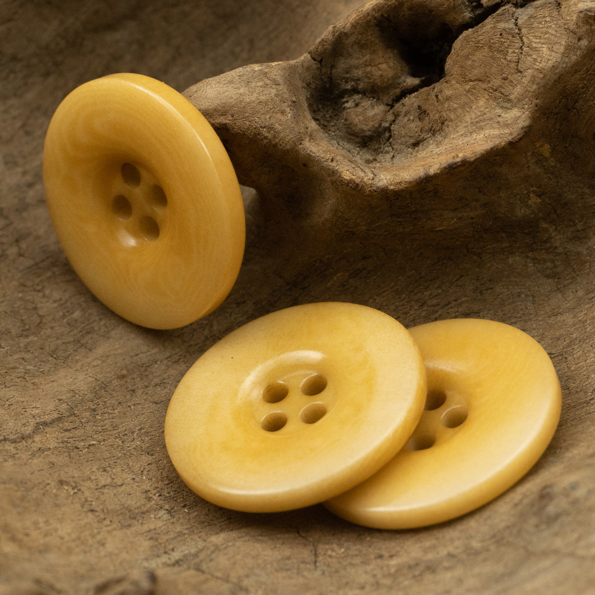 Yellow four-hole round buttons, 3-piece cluster