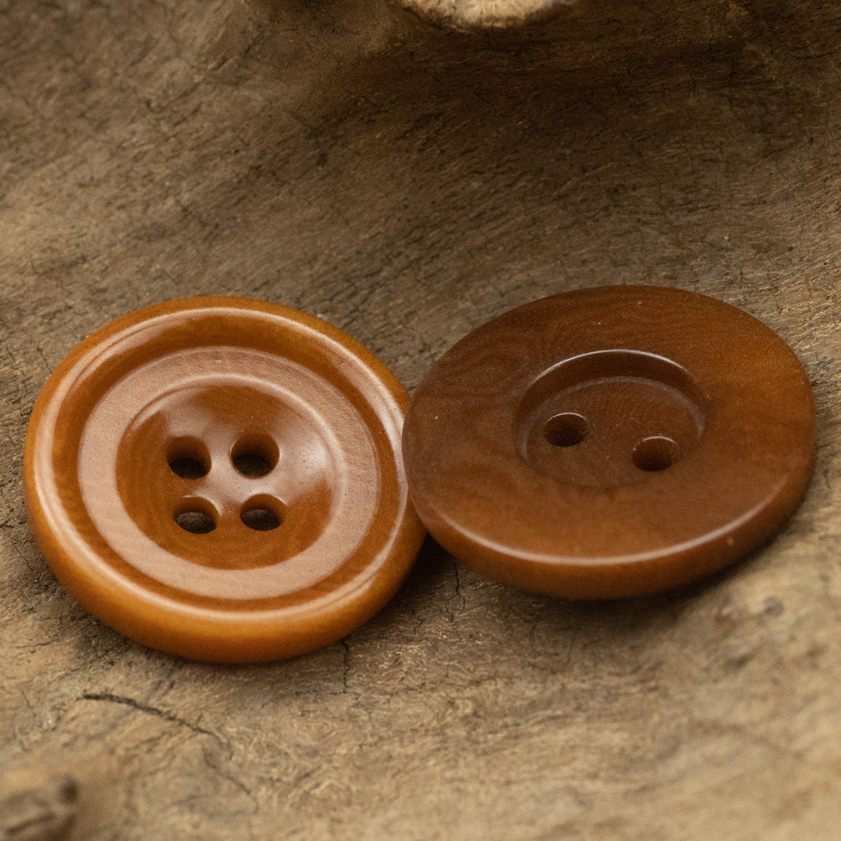 Reddish-brown round buttons close-up: 4-hole and 2-hole