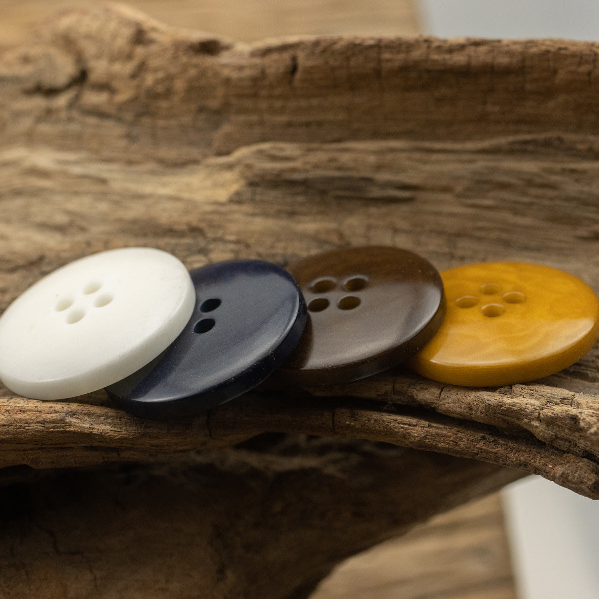 Corozo buttons in white, dark blue, coffee and khaki, each with 4 holes