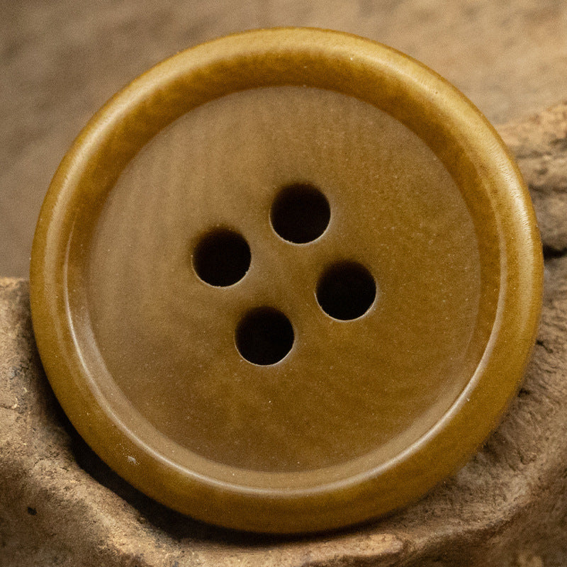 Light khaki 4-hole fruit button, round face with four shank holes