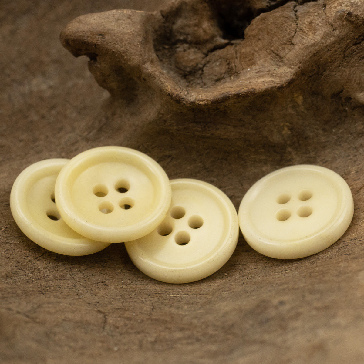 Set of light beige four-hole buttons, round bowl shape from different angles