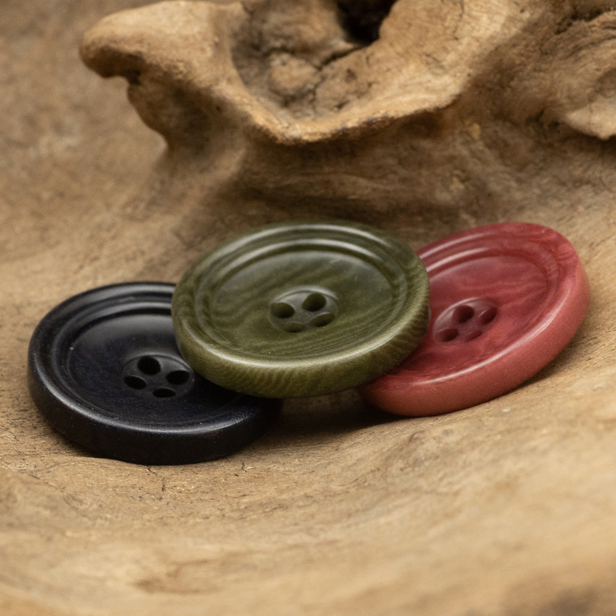Mix of army green and rose red trouser buttons, round with 4-hole center
