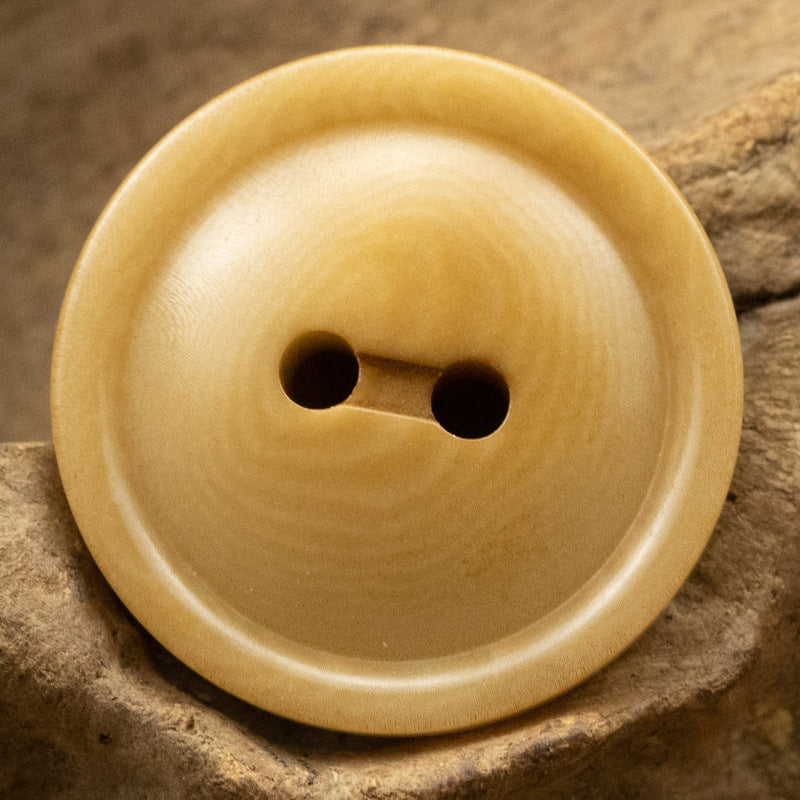 Round two-hole corozo button, warm yellow with two eyelets