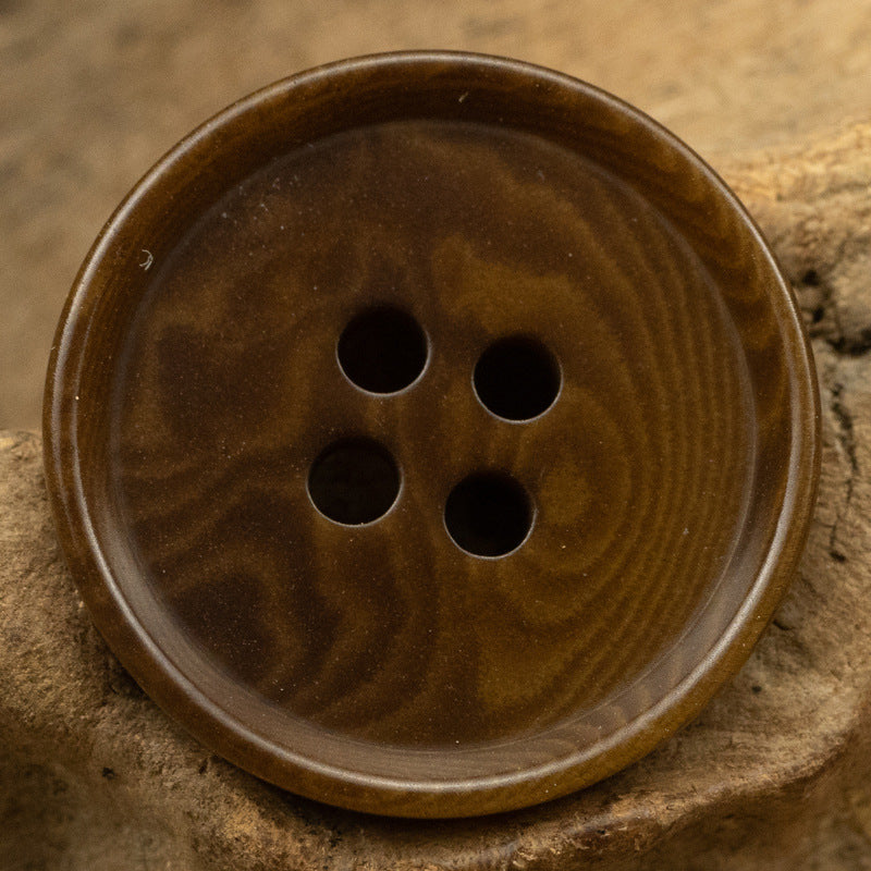 Brown round 4-hole tagut nut button, front view