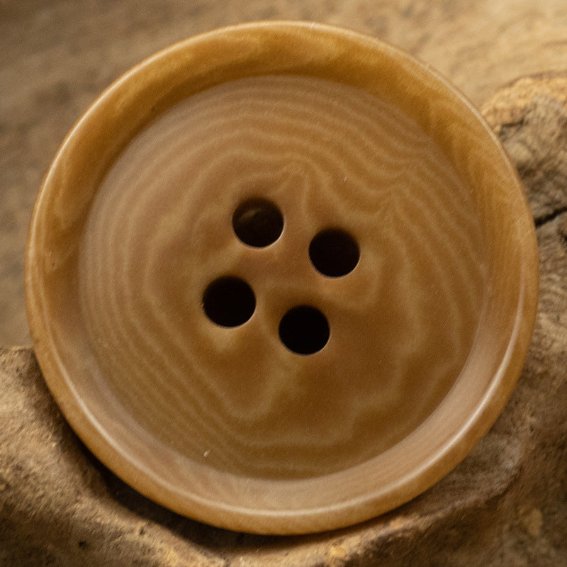 Coffee/tan four-hole tagua nut button with natural wood-like grain