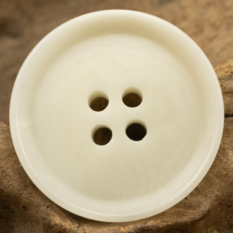 White four-hole tagua nut button, round with natural grain
