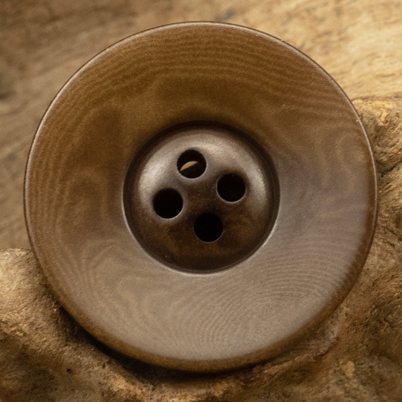 Vintage wide-edged fruit button, dark brown with four holes, round
