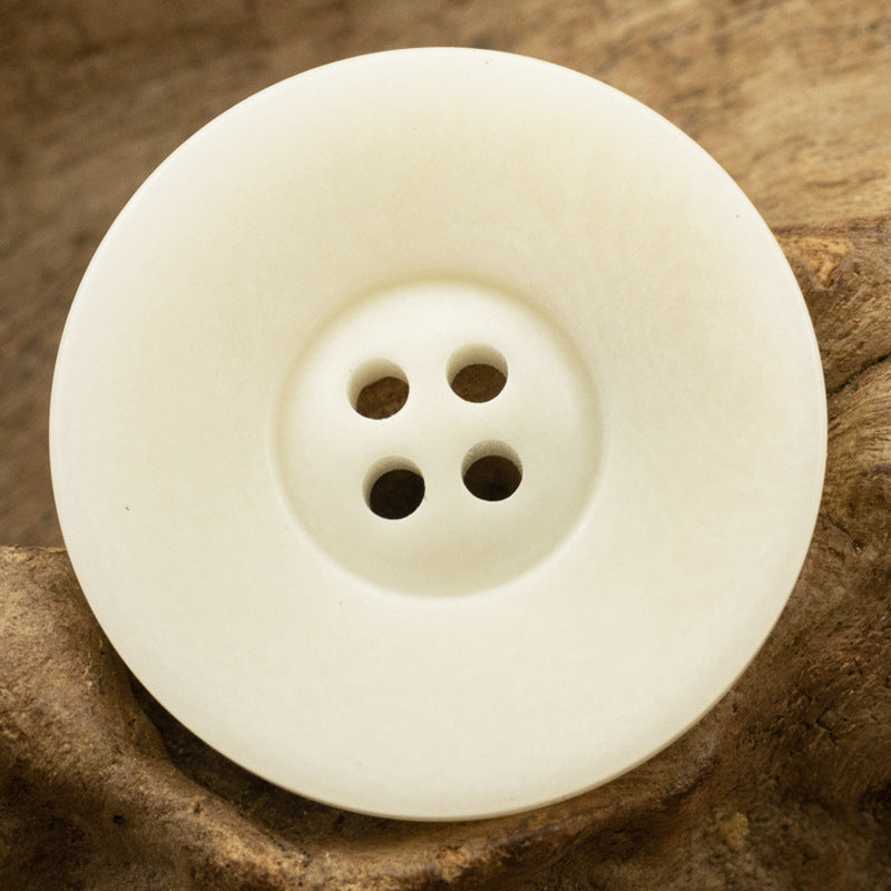 Vintage wide-edged fruit button, white with four holes, round