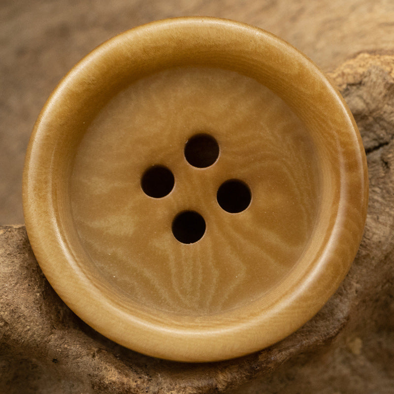 Thick-edged natural nut button, light tan color, 4 holes