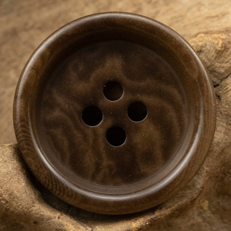 Thick-edged natural nut button, dark brown color, 4 holes
