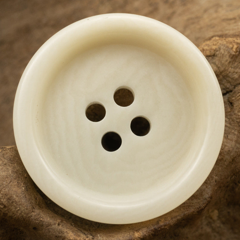 Thick-edged natural nut button, off-white color, 4 holes