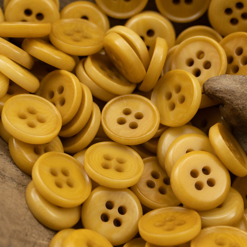 Orange natural fruit buttons, round 4-hole fronts, scattered close-up