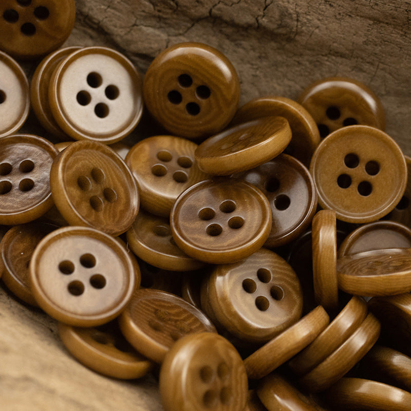 Brown natural fruit buttons with four holes and visible button shanks, assorted close-up