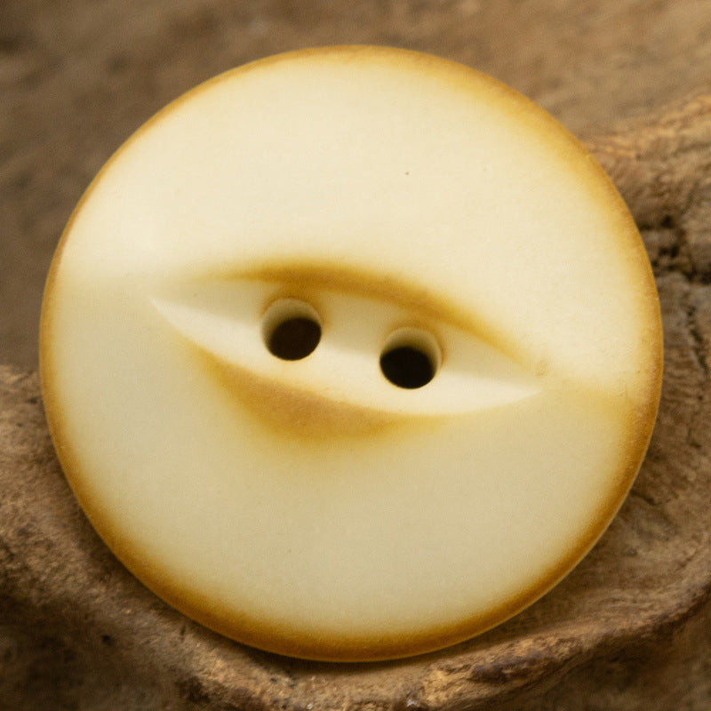 Cream beige 2-hole nut button, vintage fish-eye swirl pattern on front face