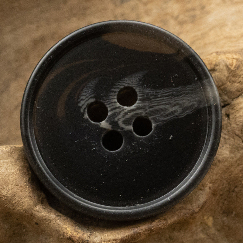 Round resin button, black with subtle tiger stripe grain, 4 holes