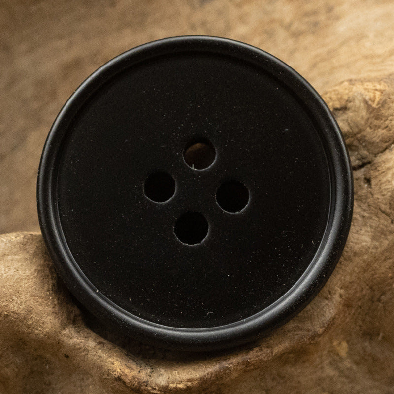 Round black resin button with 4 holes, smooth tiger stripe finish