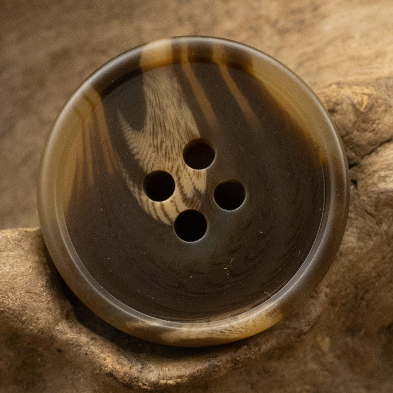 Round resin button with dark tiger stripe pattern, 4-hole design