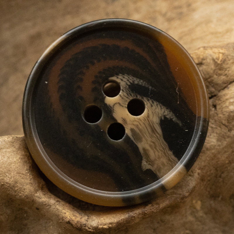 Round resin button with dark tiger stripe pattern, 4-hole design, dark amber tones