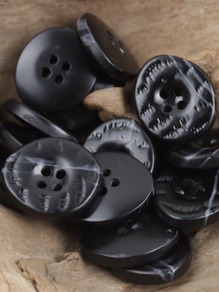 Black resin buttons with uneven surface, 4-hole, embossed pattern