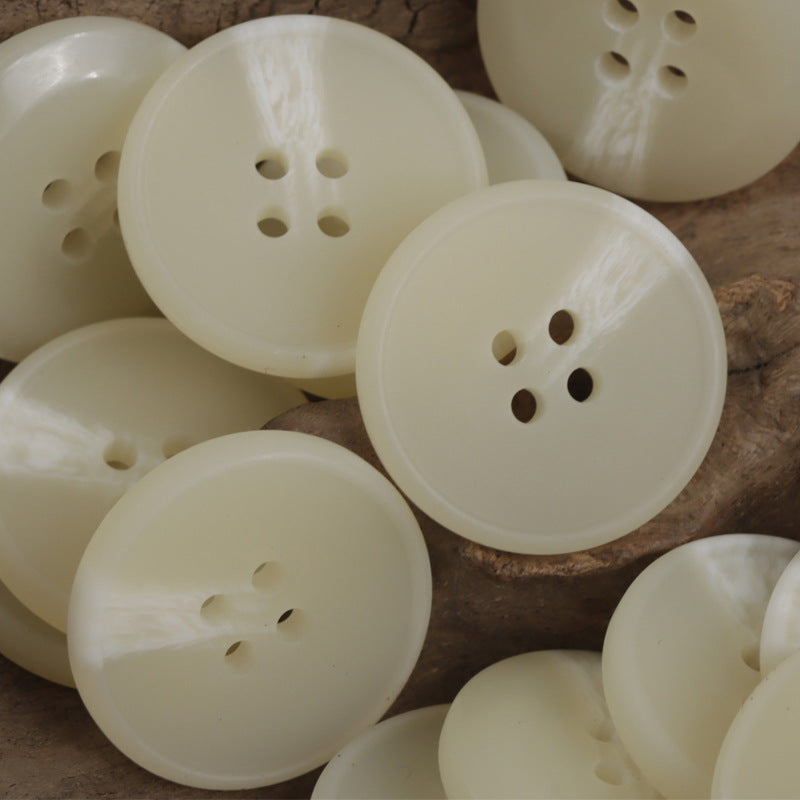 Set of Light Yellow round four-hole buttons, resin flat, close view