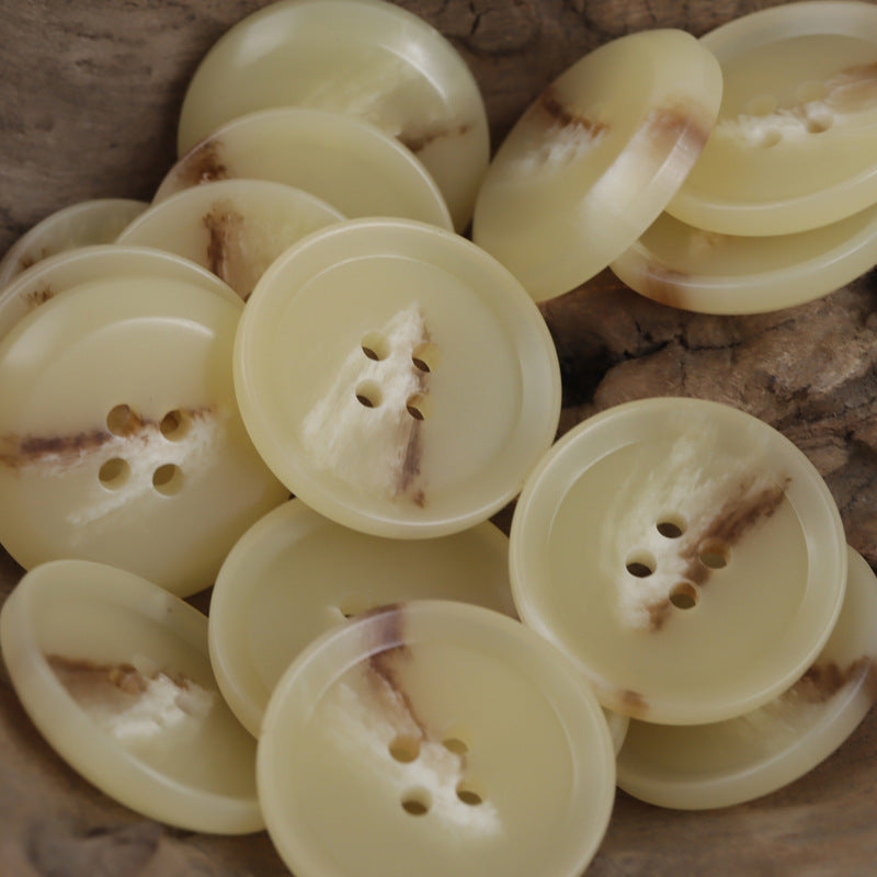 Round Light Yellow resin buttons with four holes, flat face, varied views