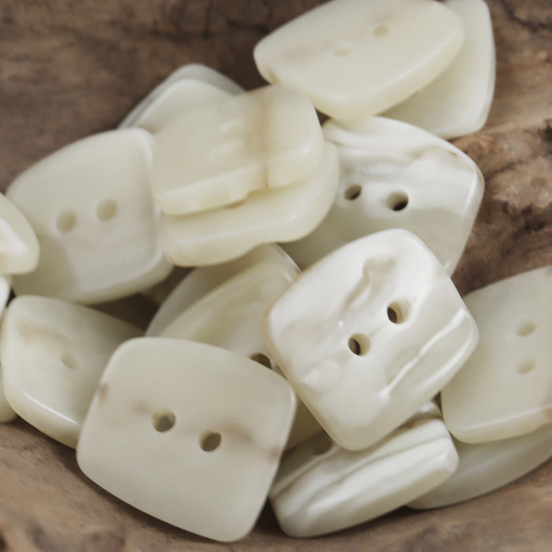 Trapezoidal 2-hole resin buttons, uneven surface, off-white color pile