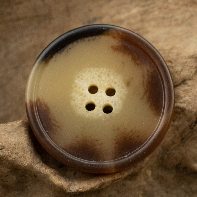 Brown yellow round resin coat button with imitation horn texture and 4 holes
