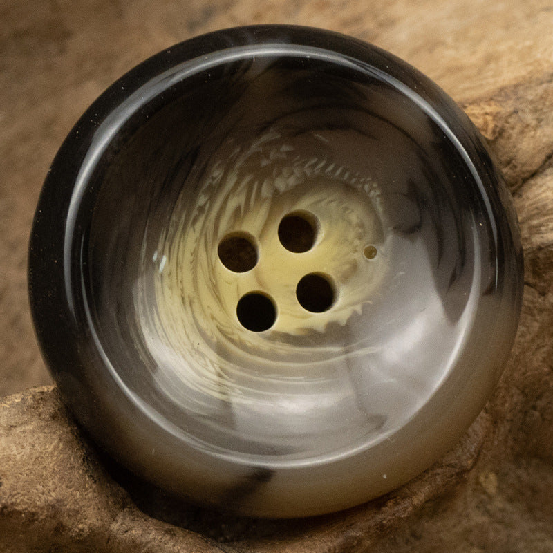 Dark round 4-hole resin suit button with brown undertone, bowl-shaped