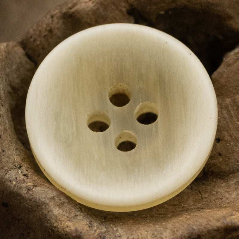 Light yellow matte resin button, 4-hole front view