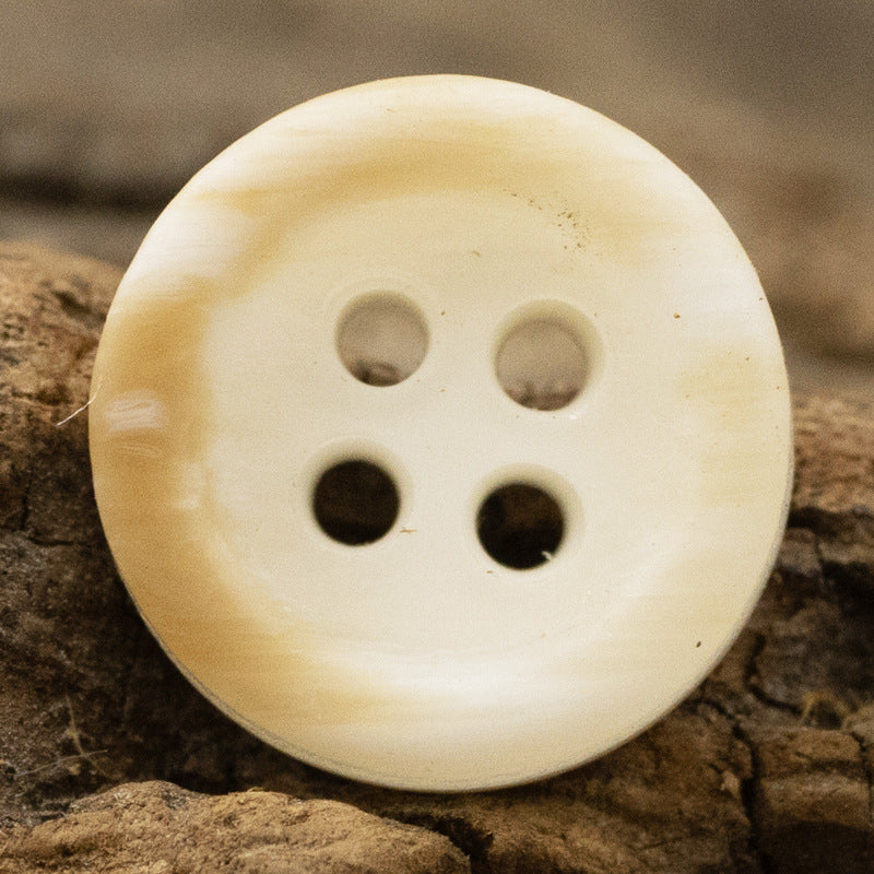 Light yellow wood grain resin button, round 4-hole front