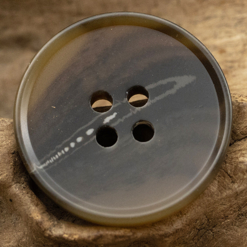 Dark blue/gray resin button with river pattern, round 4-hole face