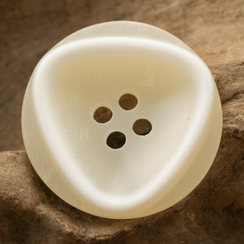 Ivory resin button with outer circle and inner triangle pattern, 4 holes