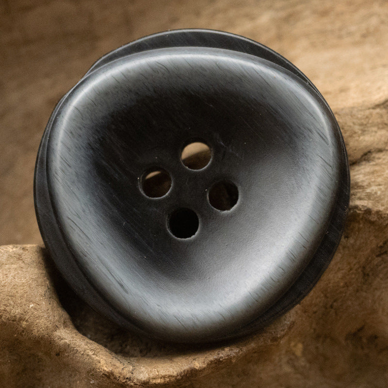 Round resin button with 4 holes, dark black-bronze sheen